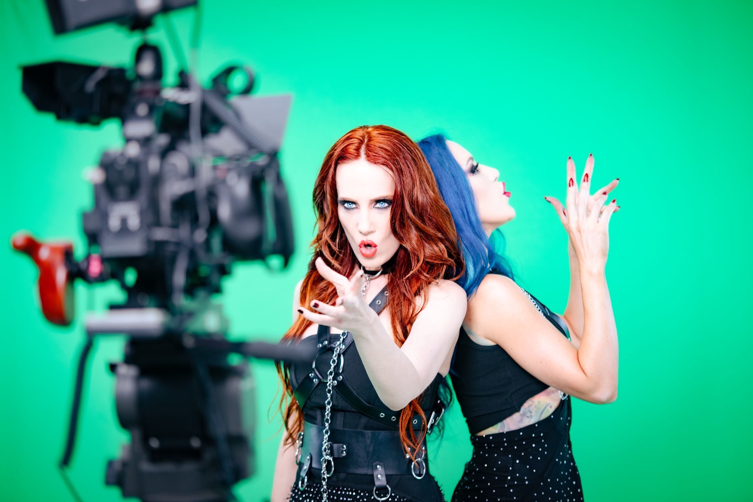 Simone Simons and Alissa White-Gluz performing on set